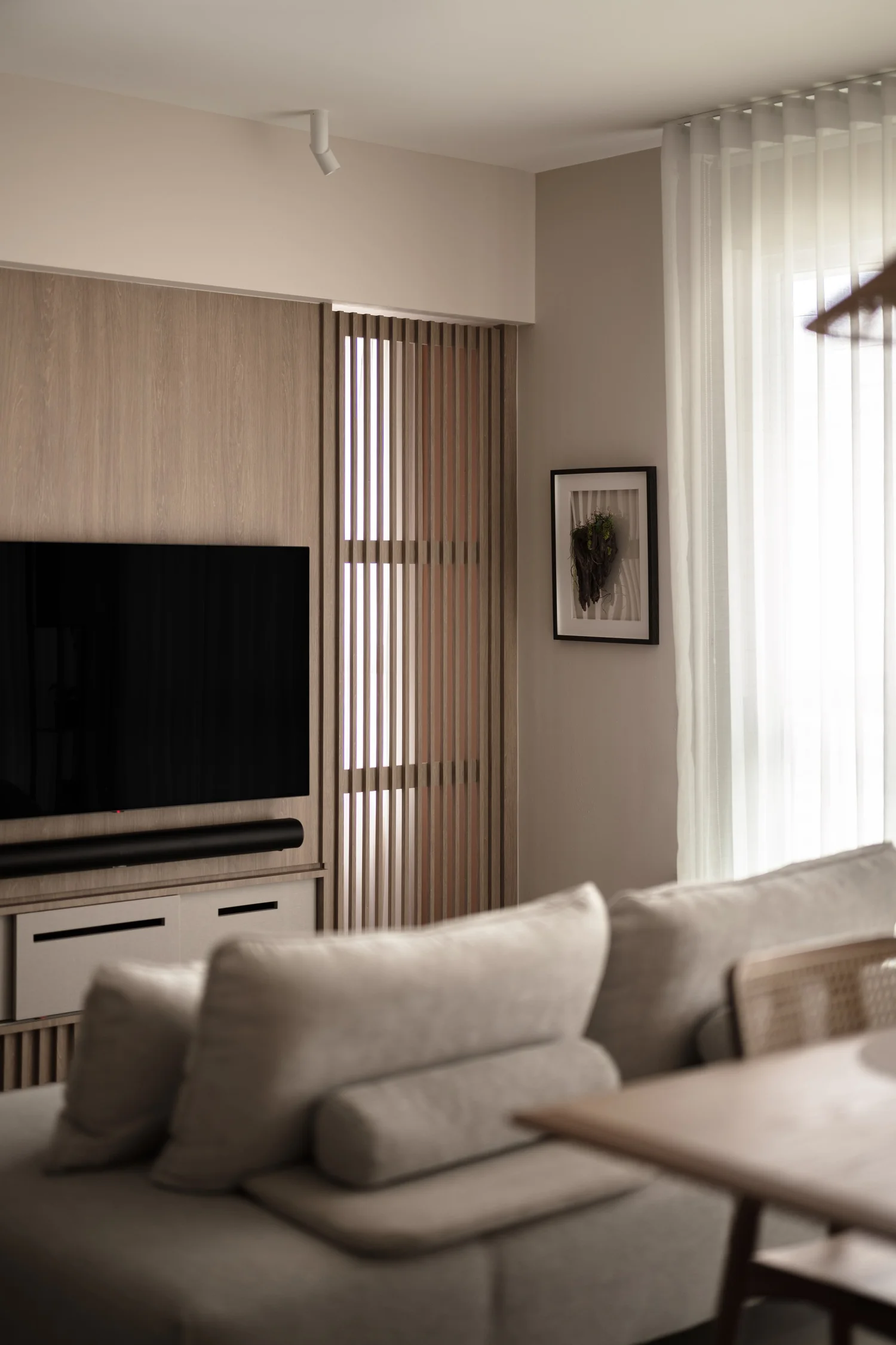 Living area with a timber TV nook and soft seating, one of HOFT's focused renovations