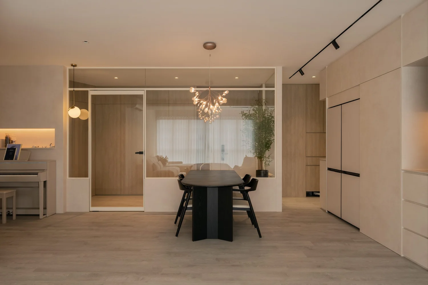 Open living and dining space with warm lighting and a full-height timber nook