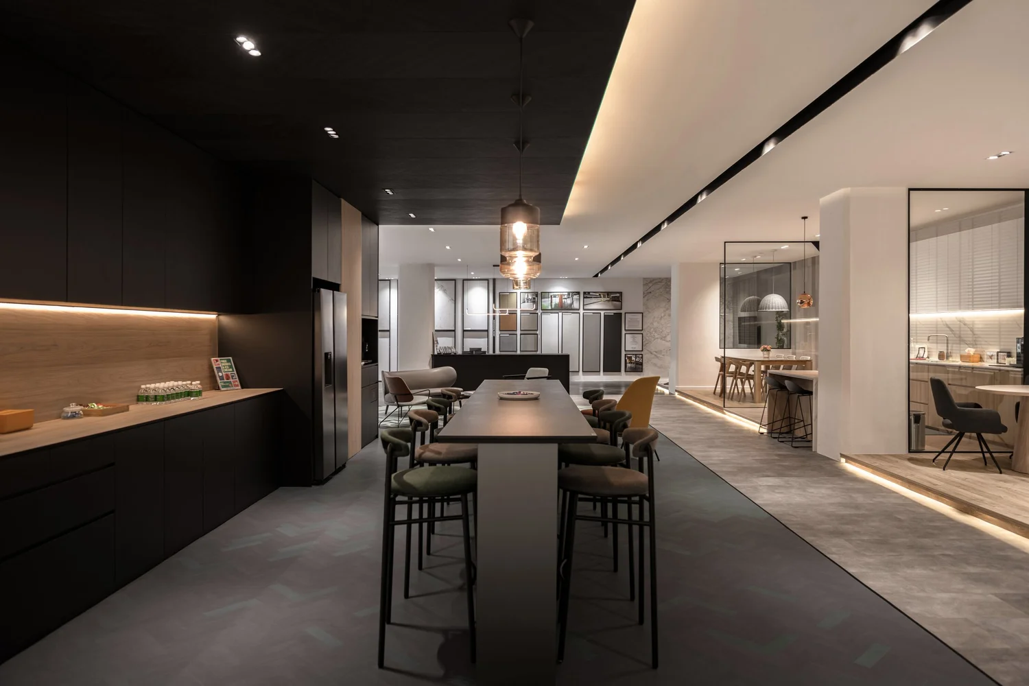 Open-plan kitchen with dark cabinetry, island bar and warm accent lighting